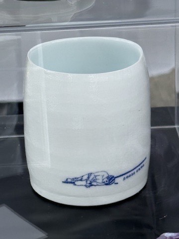 Porcelain cup with a cobalt &ldquo;Loose Ends&rdquo; illustration